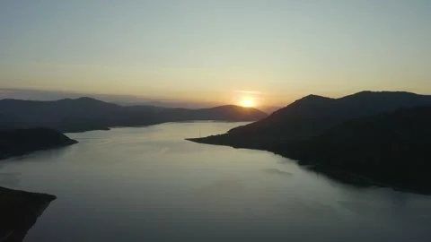 Flying on drone over a sunset lake among the mountains, east Kazakhstan, Bukhtar Stock Footage 242559149