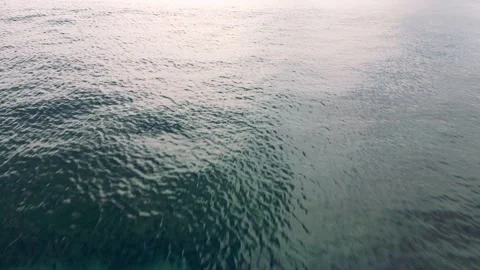 Flying a drone over the surface of the dark blue ocean. Stock Footage 238821154