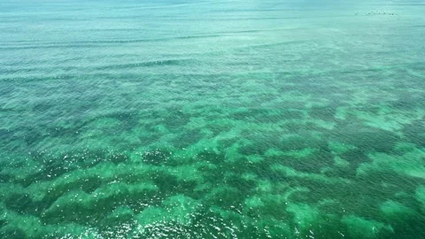 Flying a drone over the turquoise sea or ocean. Aerial view. Stock Footage 239237672