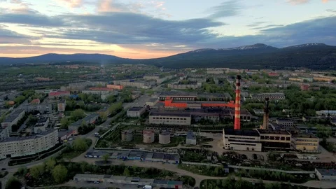 Flying drone over a typical northern Soviet city. Factories, pipes, city blocks Stock Footage 104576153
