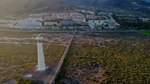 Flying a drone past the lighthouse in morro jable, fuerteventua, spain Video stock 286363056