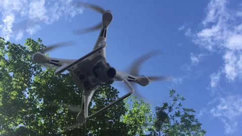 Flying Drone Quadcopter in Blue Sky Stock Footage 277023557
