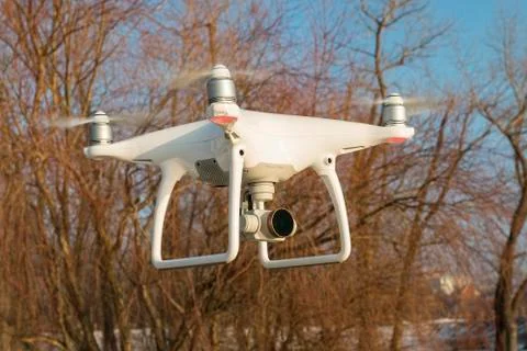 Flying drone quadcopter Dji Phantom 4 with high resolution digital camera. Stock Photos