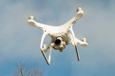 Flying drone quadcopter Dji Phantom 4 with high resolution digital camera. Stock Photos