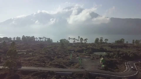 A flying drone rises from the ground and shoots a mountain. Stock Footage 155998285