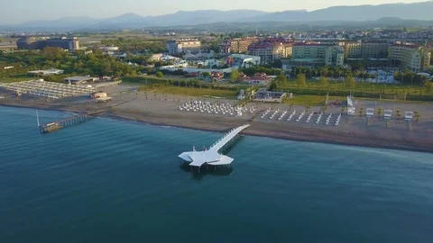 Flying a drone from the sea to the beach. Video stock 93300026