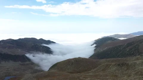 Flying with a drone through the clouds on the magnificent peaks of the Altipa	 Stock Footage 251703778