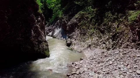 Flying a drone through a gorge over a river Stock Footage 157650092