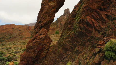 Flying a drone through a natural rock hole. Queen Shoe Teide National Park Stock Footage 221181397