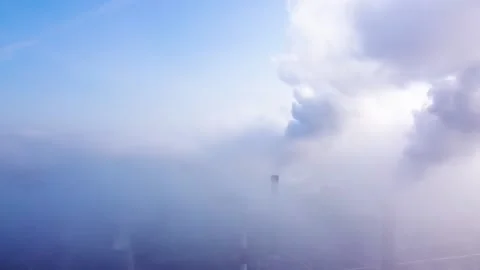Flying a drone through the smoke from the chimneys of the power station. Stockbeeldmateriaal 144225887