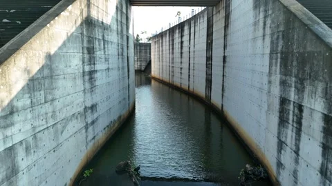 Flying a Drone Through the Spillway of the Dam Stock Footage 309915198