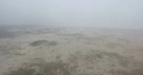 Flying a drone through thick fog at the beach Stock Footage 82022290