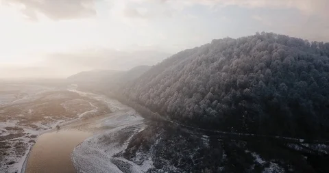 Flying drone tree in the snow beautiful mountains river Stock Footage 122601651