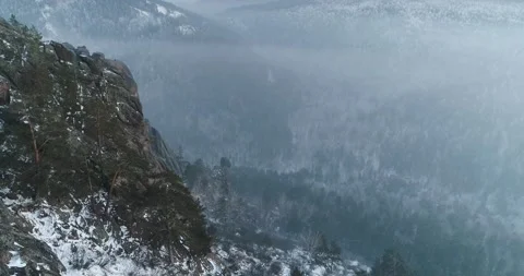 Flying a drone in winter among trees and rocks in frost Stock Footage 153663407