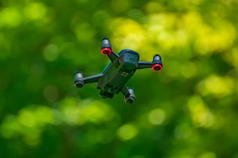 Flying drones on green background blurred Stock Photos