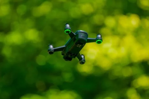 Flying drones on green background blurred Stock Photos