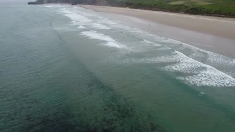 Flying to East along coast on empty beach in playa de Gerra, Cantabria, Spain 4K Stock Footage 155592991