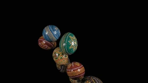 Flying Easter eggs close up against a black background. 動画素材 148889069