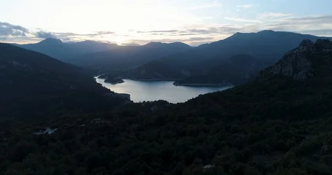 Flying establishing shot over large lake in Pyrenees in Spain drone aerial 4k Stock Footage 125755557