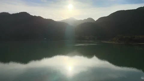 Flying into the Evening Sun over top of a Lake Stock Footage 169554257