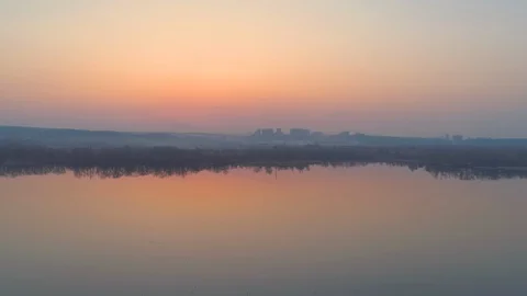 Flying extremely close to the water after sunset or sunrise Stock Footage 128310474
