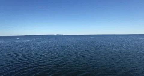 Flying fast and low over lake Vättern. Sunny day with blue sky. Stock Footage 87297224