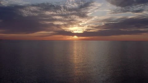 Flying Fast Away From Setting Sun on Horizon in breathtaking Great Lakes Aerial Stock Footage 137672426