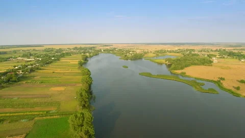 Flying fast over fields and river Stock Footage 100662040