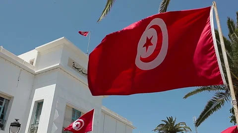 Flying flag of Tunisia in front of the administrative building. Sousse, Tunisia Stock Footage 39980051