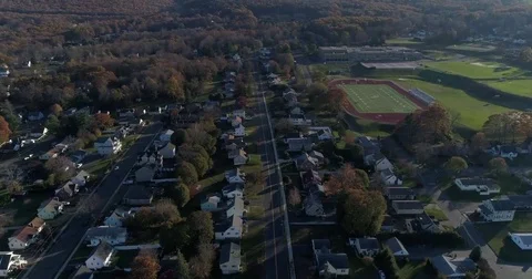 Flying forward and over high altitude towards Bristol CT central high school Stock Footage 82326655