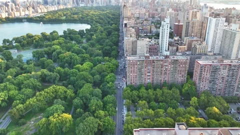 Flying Forward on Central Park West, Tilt Up Reveal of Midtown Skyline Stock Footage 345293694