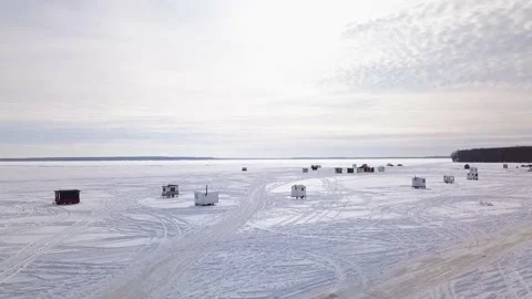 Flying forward with a drone high above the frozen lake with the sun setting Stock-Footage 152422896