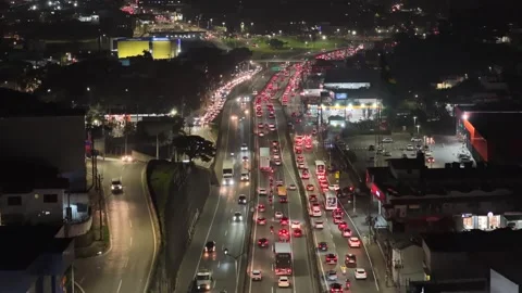 Flying forward at night over raposo tavares highway traffic and roadside shops Vídeo Stock 342647048