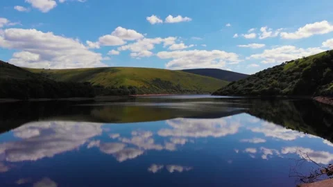 Flying forward over cloud reflections on Meldon resevoir, Devon, UK 動画素材 135519688