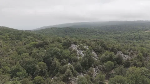 Flying forward over a hazy mountain with clouds Stock Footage 288725120