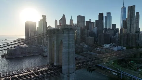 Flying Forward Past the Brooklyn Bridge Into the Low Sun Video stock 345290923