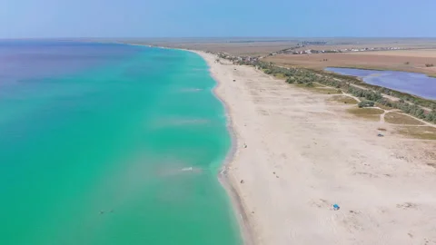 Flying forward with a rise to the top over the sea coastline with emerald Stock Footage 155706473