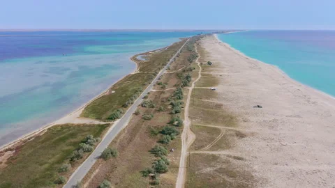 Flying forward with a turn to the left over the sea coastline with emerald Stock Footage 155730961