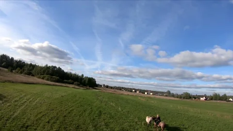 Flying on an fpv drone behind a horse, a girl on a horse Stock Footage 166831076