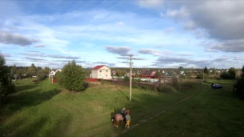 Flying on an fpv drone behind a horse, a girl on a horse Stock Footage 166833741