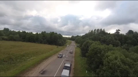 Flying fpv drone behind two cars Stock Footage 208617500