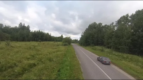 Flying fpv drone behind two cars Stock Footage 208617554