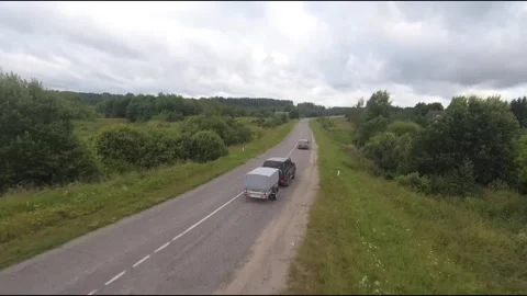 Flying fpv drone behind two cars Stock Footage 208617623