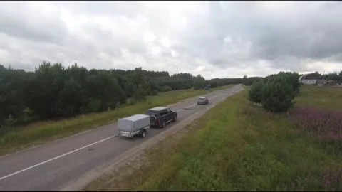 Flying fpv drone behind two cars Stock Footage 208617793