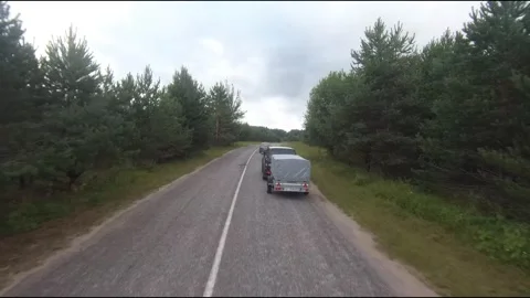 Flying fpv drone behind two cars Stock Footage 208617862