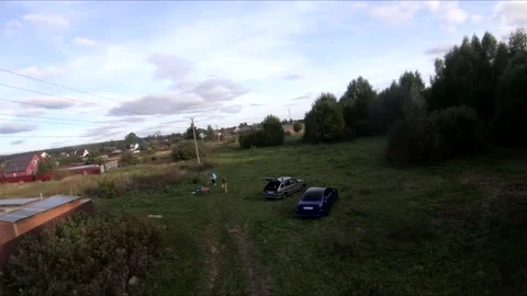 Flying on an fpv drone in a green field, against the background of a forest Stock Footage 166835487