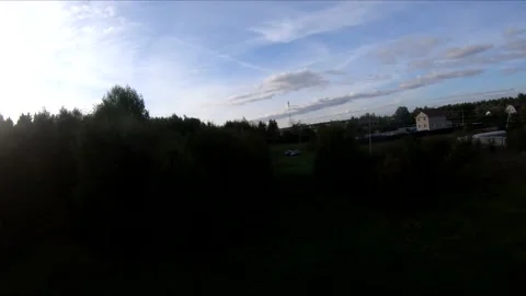 Flying on an fpv drone in a green field, against the background of a forest Stock Footage 166836006