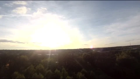 Flying on an fpv drone in a green field, against the background of a forest Stock Footage 166836468