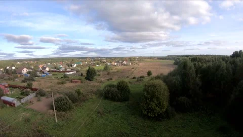 Flying on an fpv drone in a green field, against the background of a forest Stock Footage 166840966