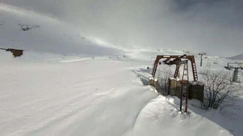 Flying an FPV drone in the mountains in winter white snow Stock Footage 234379723